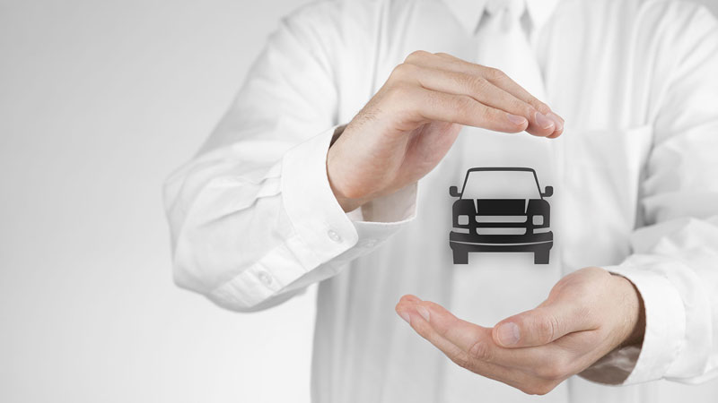 A person in white shirt holding their hands around a car icon