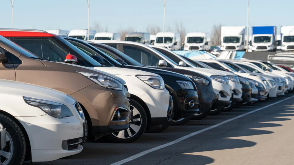 Many used cars parked in a dealership's large place