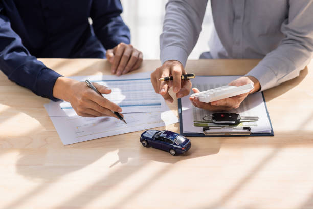 A person analyzing financial documents and charts, symbolizing financial planning and analysis.