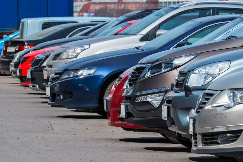 A row of parked cars in a parking lot.