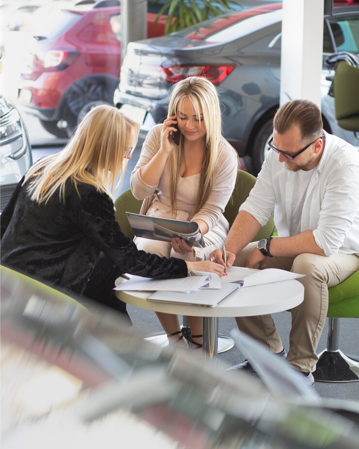 Three person discussed about used car sales